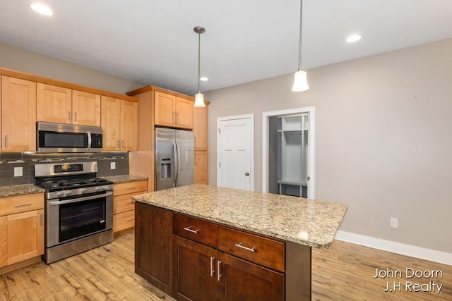 kitchen featuring tasteful backsplash, light brown cabinets, baseboards, light wood-style floors, and stainless steel appliances