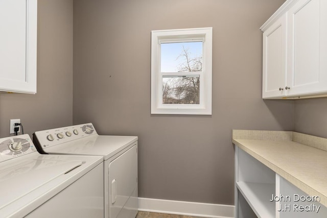 laundry room with cabinet space, independent washer and dryer, and baseboards