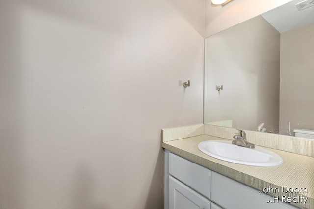 half bath featuring visible vents and vanity