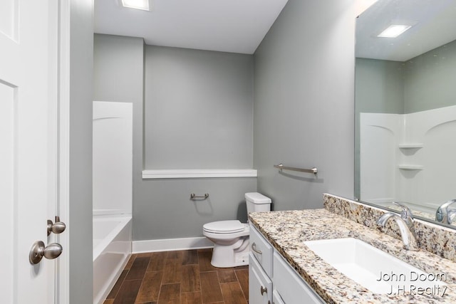 full bathroom with baseboards, toilet, vanity, and wood finish floors