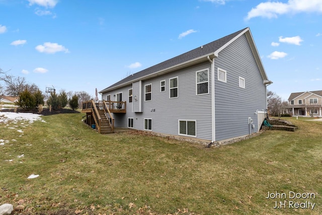 view of property exterior with a deck, stairway, and a lawn