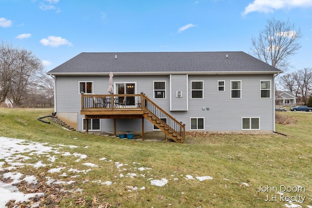 back of house featuring stairway, a lawn, a deck, and a shingled roof