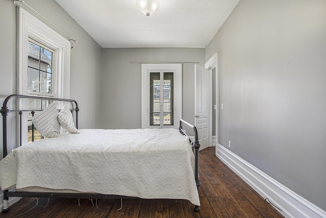 bedroom featuring dark wood-type flooring and baseboards