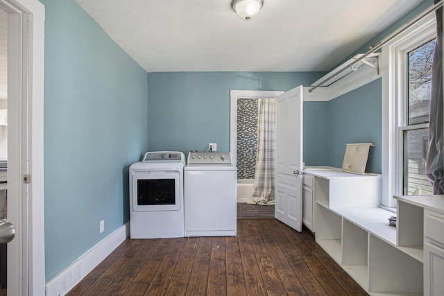 washroom featuring visible vents, baseboards, laundry area, separate washer and dryer, and dark wood-type flooring