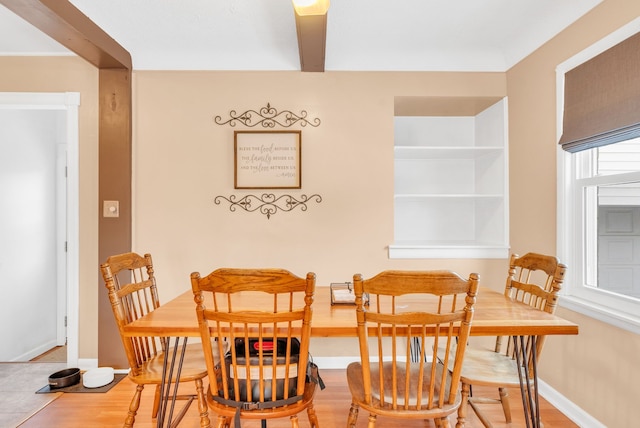 dining area featuring baseboards and wood finished floors