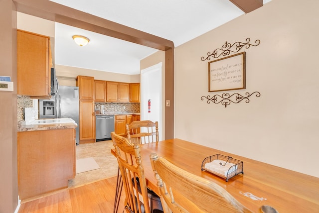 dining space featuring light wood-style flooring