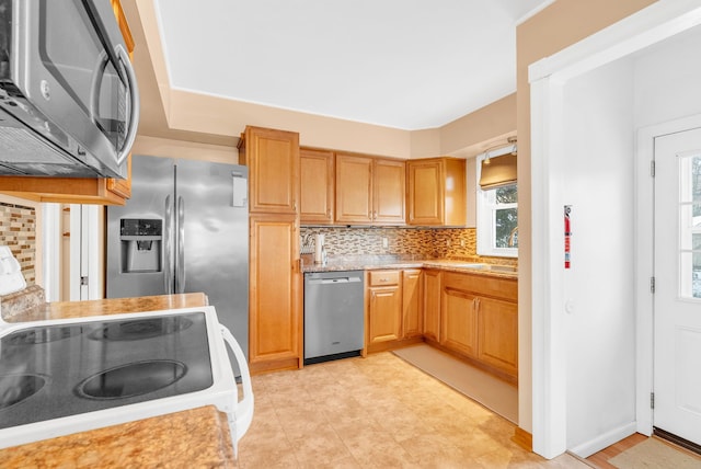 kitchen featuring decorative backsplash, a wealth of natural light, and appliances with stainless steel finishes