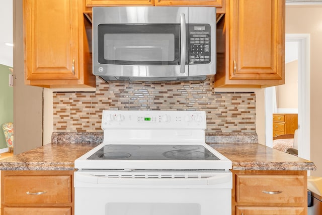 kitchen featuring white range with electric cooktop, stainless steel microwave, backsplash, and light countertops