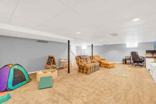 rec room with a drop ceiling, baseboards, and carpet