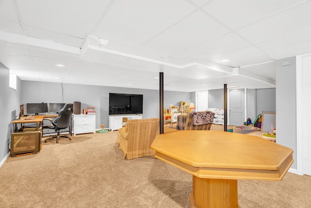 carpeted office space with a drop ceiling and baseboards