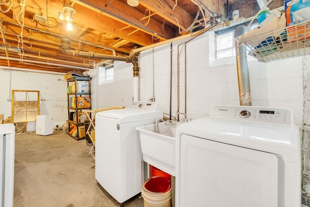 laundry room featuring washer and dryer, a wealth of natural light, and laundry area