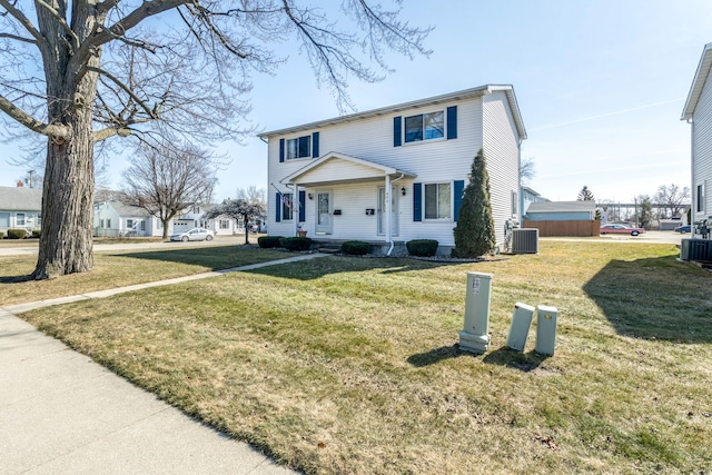 view of front of property featuring central AC and a front lawn