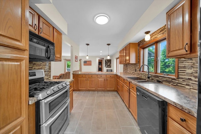 kitchen featuring a wealth of natural light, light tile patterned floors, black appliances, and a sink