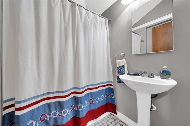 full bath featuring curtained shower and a sink