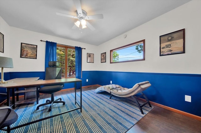 home office with a ceiling fan, wood finished floors, and baseboards