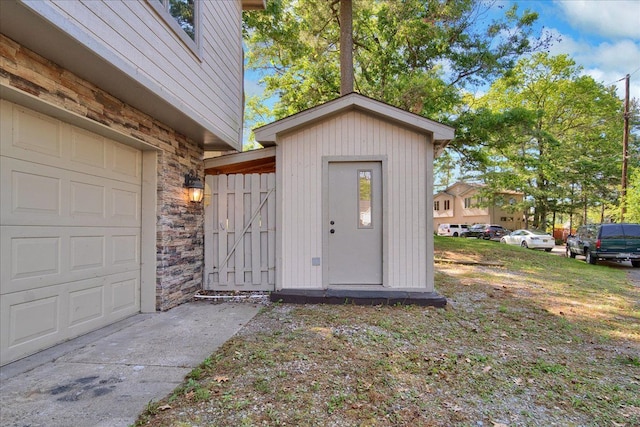 exterior space with a garage and stone siding