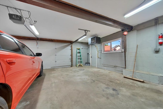 garage featuring a garage door opener and concrete block wall