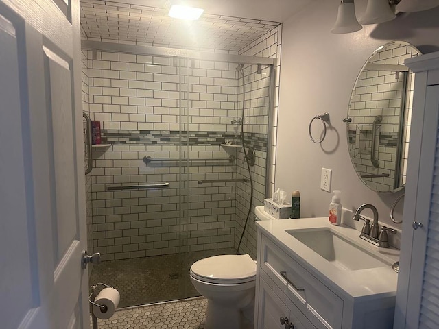 full bathroom featuring tile patterned flooring, vanity, a shower stall, and toilet