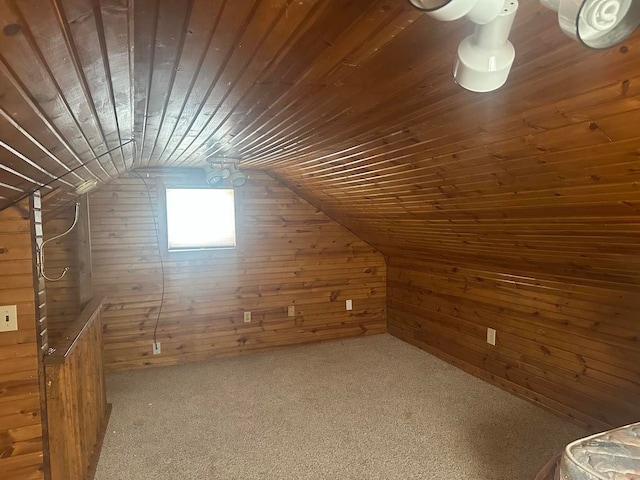 additional living space with carpet floors, wooden walls, wood ceiling, and vaulted ceiling