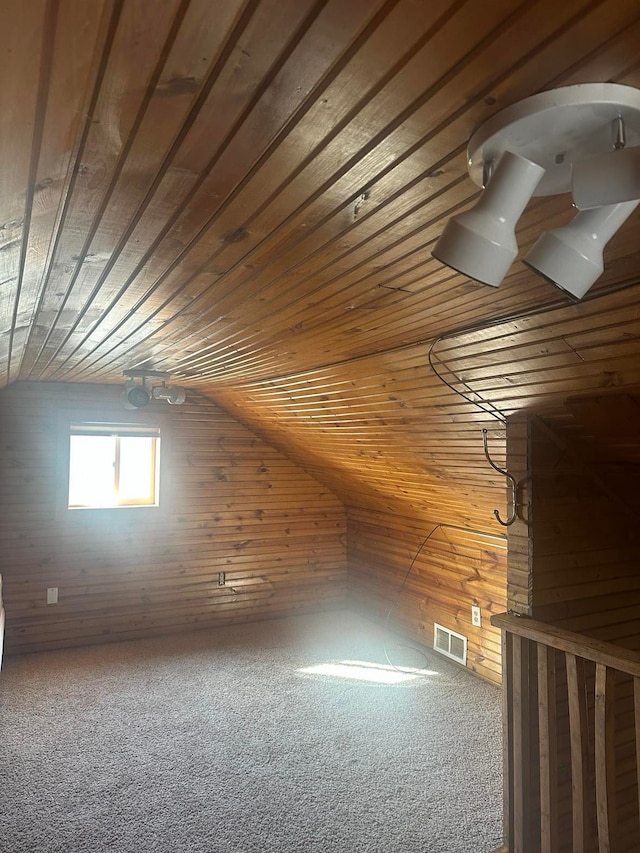 bonus room with visible vents, wooden walls, carpet, wooden ceiling, and lofted ceiling