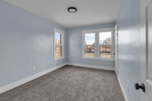 unfurnished room featuring baseboards and carpet flooring