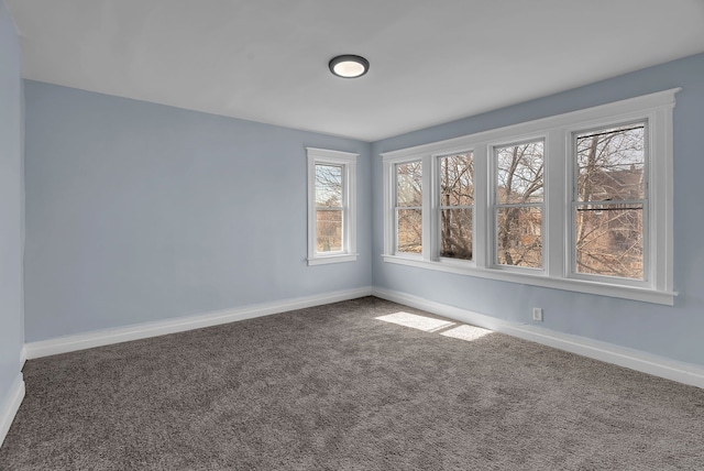 unfurnished room with baseboards and carpet