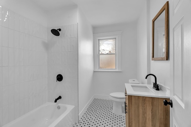 bathroom featuring vanity, toilet, baseboards, and shower / washtub combination