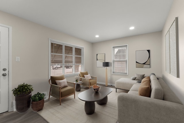 living room with a wealth of natural light, baseboards, wood finished floors, and recessed lighting