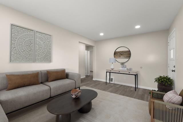 living area featuring wood finished floors, recessed lighting, baseboards, and visible vents