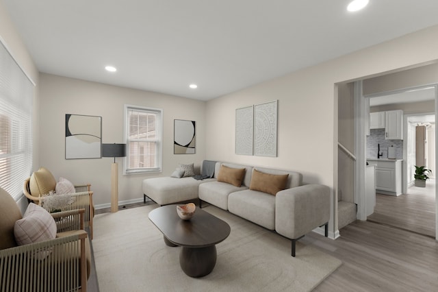 living area featuring recessed lighting, light wood-type flooring, and baseboards