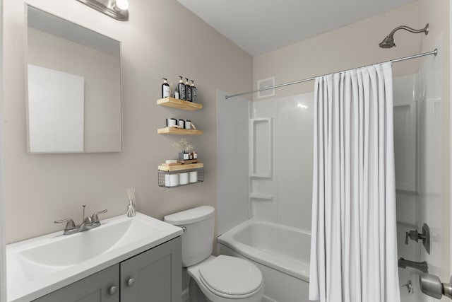 bathroom with toilet, vanity, and shower / bath combo