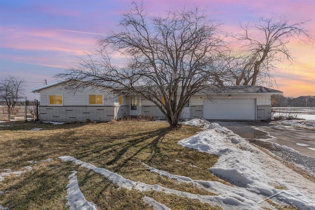 view of front of property with a garage, brick siding, concrete driveway, and fence