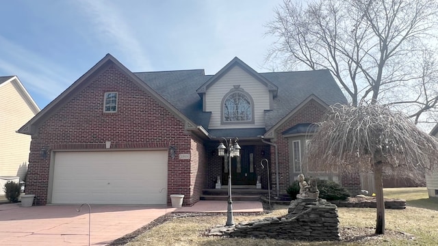 view of front of home with a garage, brick siding, and driveway