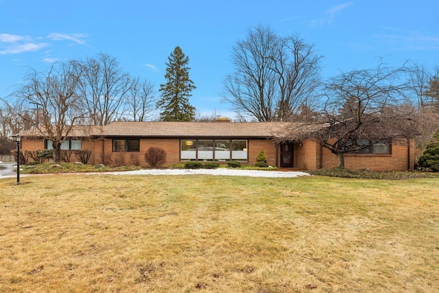 view of front of home with brick siding and a front lawn