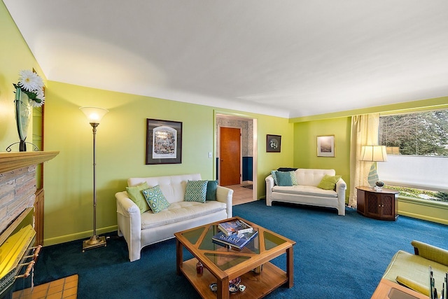 carpeted living room with a glass covered fireplace and baseboards