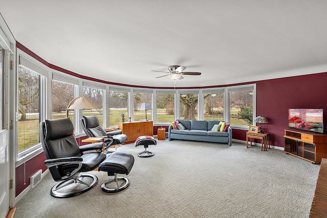 sunroom / solarium with visible vents and ceiling fan