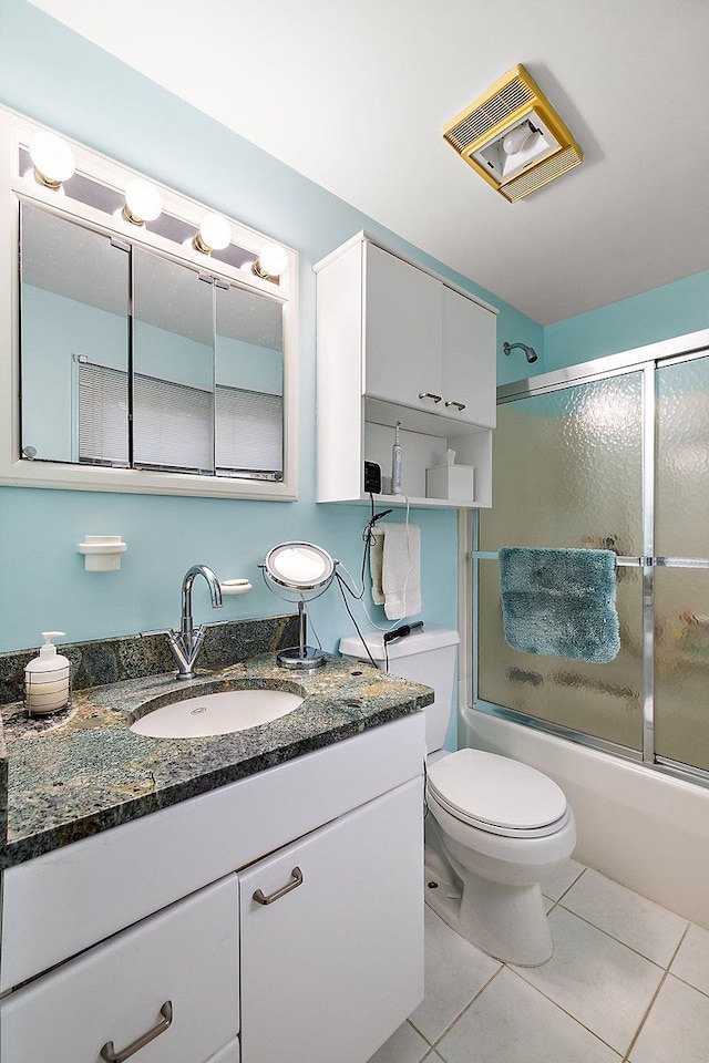 bathroom featuring visible vents, toilet, tile patterned flooring, enclosed tub / shower combo, and vanity