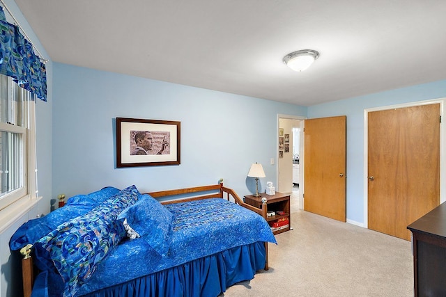 carpeted bedroom featuring baseboards