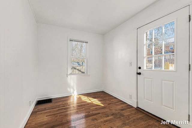 entryway with wood finished floors, visible vents, and baseboards