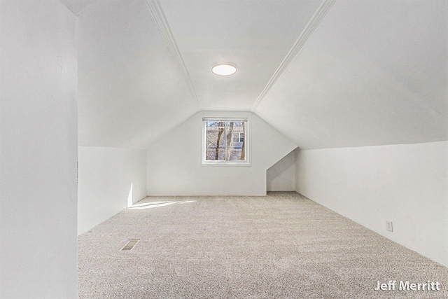 additional living space featuring lofted ceiling and carpet flooring