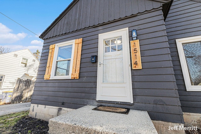 view of exterior entry with fence