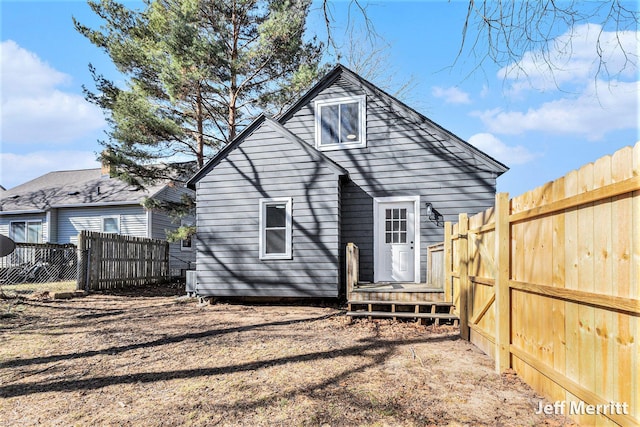 rear view of property with a fenced backyard