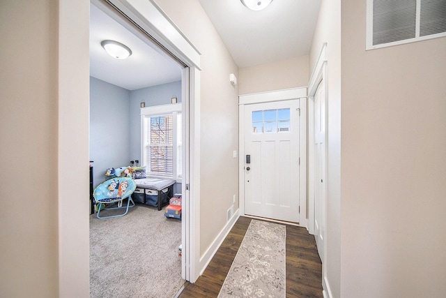 entryway with visible vents, baseboards, and dark wood-style floors