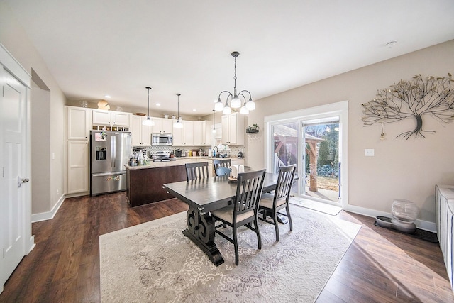 dining room featuring recessed lighting, baseboards, dark wood-type flooring, and a chandelier