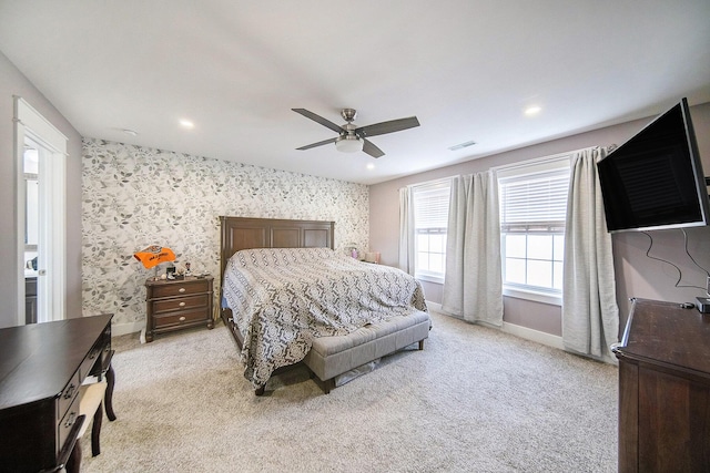 bedroom featuring visible vents, light colored carpet, and wallpapered walls