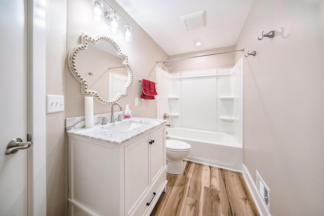 full bath with vanity, wood finished floors, visible vents, shower / washtub combination, and toilet