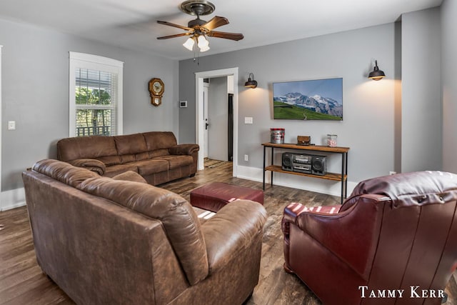 living room with baseboards, ceiling fan, and wood finished floors