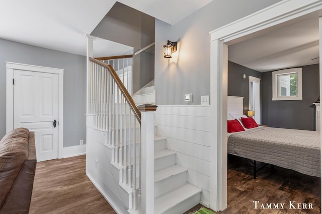 staircase with baseboards and wood finished floors