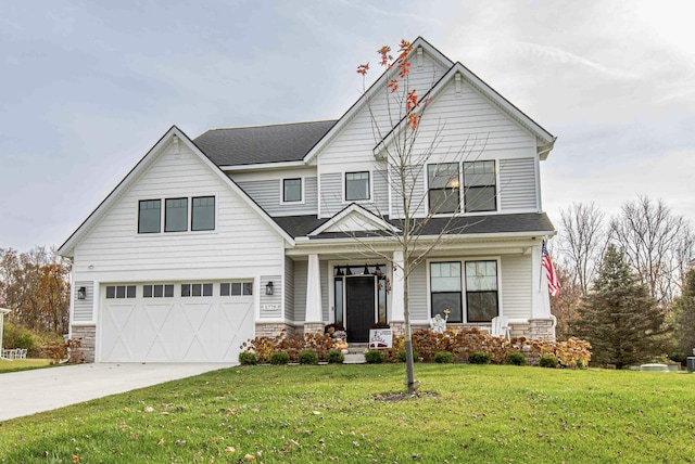 view of front of home with concrete driveway, a garage, a front yard, and roof with shingles