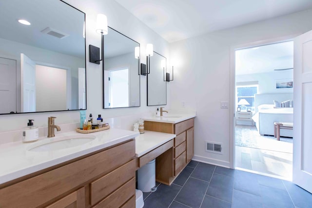 full bathroom featuring tile patterned flooring, visible vents, vanity, and baseboards